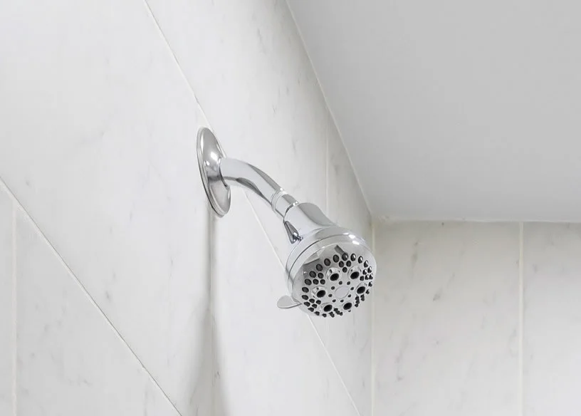 Fixed shower head in a bright bathroom